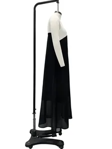 Side view of a sleeveless black and white color-block maxi dress on a mannequin