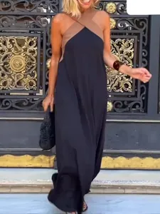 Detail view of stylish sleeveless halter maxi dress with brown and black color blocking.