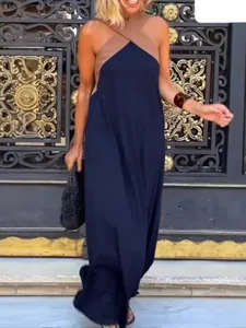 Close-up view of elegant navy and tan halter neck color-block maxi dress with sleeveless design