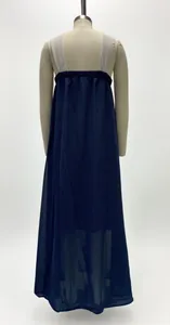Back view of a navy blue sleeveless maxi dress with sheer paneling on mannequin