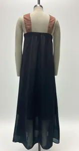 Detailed back view of a long sleeveless black maxi dress with contrast brown straps