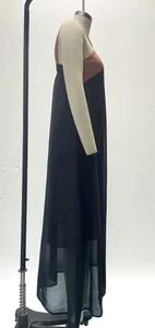 Detailed side view of a two-tone sleeveless maxi dress featuring a sheer layered hem