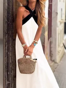 Elegant summer maxi dress for women featuring a black halter neck and white flowy skirt