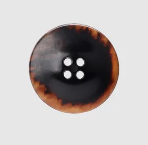 Close-up detail of high-end urea button with four holes and tortoiseshell pattern