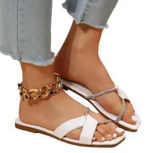 Elegant women's white flat sandals featuring sparkly rhinestone straps for beach and summer parties