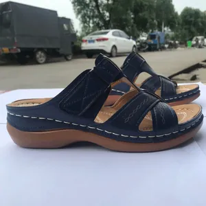 Comfortable navy blue wedge sandals with hollow-out cross straps and stitching detail