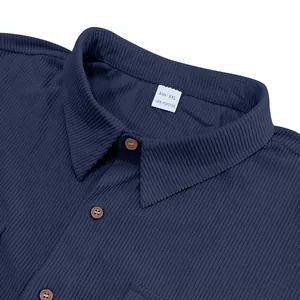 Close-up detail showing the texture and collar of a blue corduroy work shirt with tag
