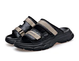 Detailed view of men's casual black sandals with beige straps and thick foam soles