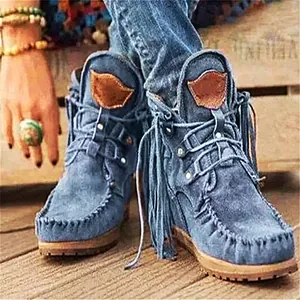 Detail von blauen Western-Stiefeletten mit Bohemian-Fransen und Mokassin-Nähten.
