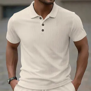 Close-up of cream men's polo shirt featuring heavy jacquard texture and buttons