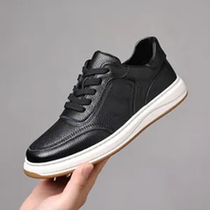 Side view of a black genuine leather men's casual sneaker with white platform sole