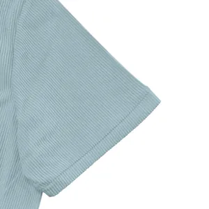 Close-up detail of light blue corduroy shirt sleeve showing premium fabric texture