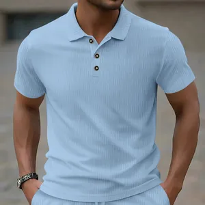 Close-up view of light blue jacquard polo shirt featuring textured geometric pattern