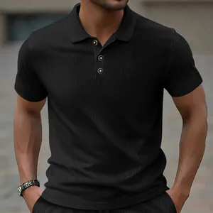 Close-up of black jacquard polo shirt with textured pattern and classic collar