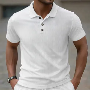 Close-up detail of white textured jacquard fabric and button placket on men's polo shirt