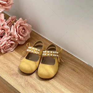 Elegant yellow toddler girl princess sandals with pearls and bow accents for summer wear