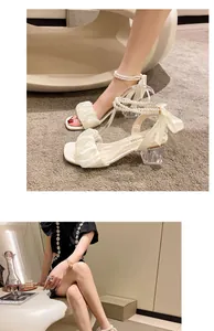 Elegant white square toe high heel sandals with pearl ankle straps and ruffles for women.