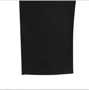 Detailed macro view of the hem and breathable fabric on black linen casual trousers