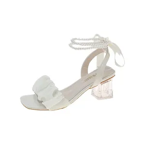Elegant white square toe high heel sandals featuring pearl straps and a ribbon tie
