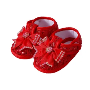Elegant red sequined baby princess shoes featuring large bow and shiny rhinestone accents