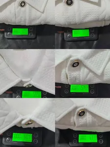 Close-up of white jacquard men's polo set featuring ornate gold buttons on a scale.