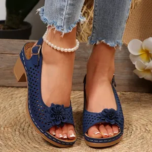 Detailed view of blue hollow out summer sandals featuring a 3D flower and chunky heel