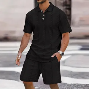 Macro detail of men's summer set featuring a premium black jacquard cable knit texture