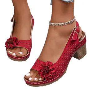 Stylish red chunky heel sandals featuring hollow-out pattern and decorative floral design.