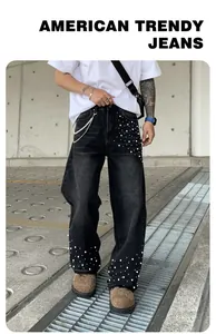 Detailed view of men's loose straight-leg jeans with stylish pearl embellishments