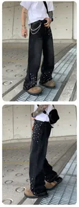 Streetwear men's loose straight denim jeans with white pearl studs in washed black.