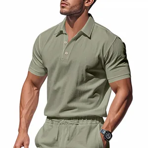Detail of a men's sage green linen polo shirt with textured fabric and classic collar.