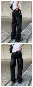 Detail of men's loose straight-leg jeans with pearl bead accents on lower legs.