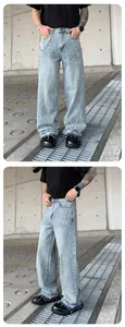 Detail view of men's loose straight denim jeans with decorative pearl bead accents