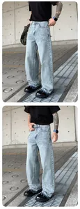 Detailed view of men's loose straight leg denim pants featuring white beaded studs
