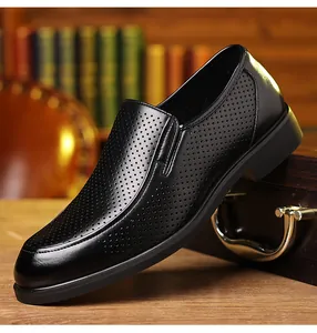 Side view showing breathable perforated texture of black leather dress shoes for men