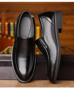 Detail view of men's black breathable leather dress shoes with perforated design