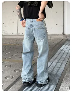 Detailed back view of men's loose straight jeans featuring decorative pearls at the hem.