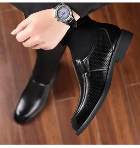 Detail of black perforated leather business shoes for men in a professional setting