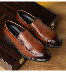 Detail view of brown perforated leather men's business dress shoes on a wooden display box
