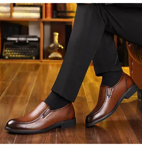Detail view of brown perforated leather dress shoes for men in a classic style