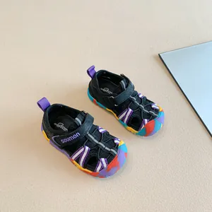 Close-up of children's colorful closed-toe sports sandals with mesh and Velcro strap.