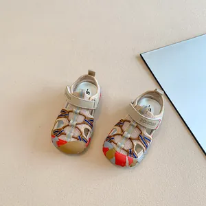 Close-up of stylish closed-toe children's sport sandals with mesh and cord detail