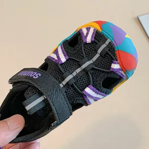 Close-up view of children's outdoor closed-toe sandal with a colorful rubber toe cap