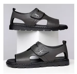 Detailed side view of grey leather men's Roman sandals with hook-and-loop straps.