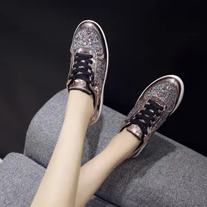 Close-up of stylish rose gold mirror sneakers featuring colorful diamond sequins