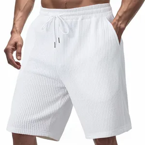 Detailed view of white men's waffle jacquard sports shorts with drawstring waist