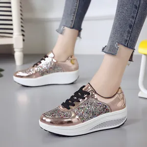 Close-up of rose gold mirror rocking shoes with colorful sequin details and platform sole