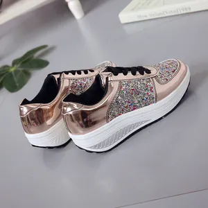 Detail view of women's rose gold mirror sneakers with colorful glitter panels