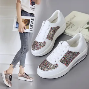 Close-up of women's platform rocking shoes with colorful glitter sequins and mirror finish