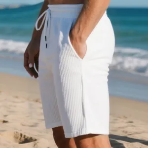Close-up of men's white ribbed texture beach shorts featuring drawstring waist